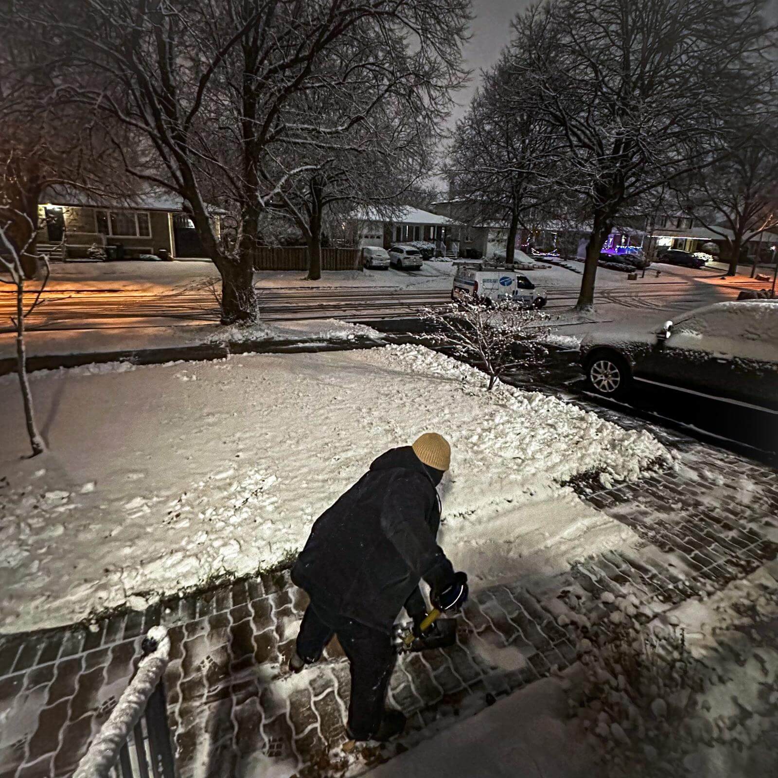 Professional residential snow removal and driveway clearing services during a winter snowstorm in Toronto.