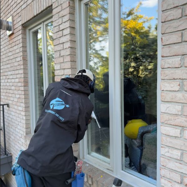 Silverlight Windows and Eaves technician providing professional window cleaning services for a Leaside residence.