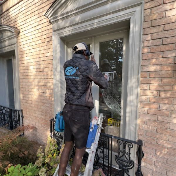 Silverlight Windows and Eaves technician providing a hand-detailed window clean for a historic residence in The Annex, Toronto.