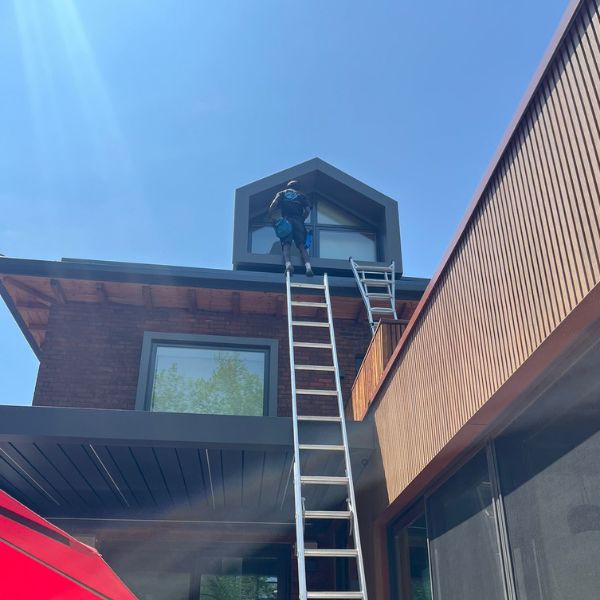 Stafan Lionel performing high-reach window detailing on a modern home in Toronto.